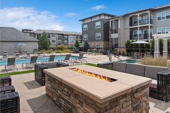 poolside patio and fireside lounging area with comfortable seating at Carrick Bend apartments
